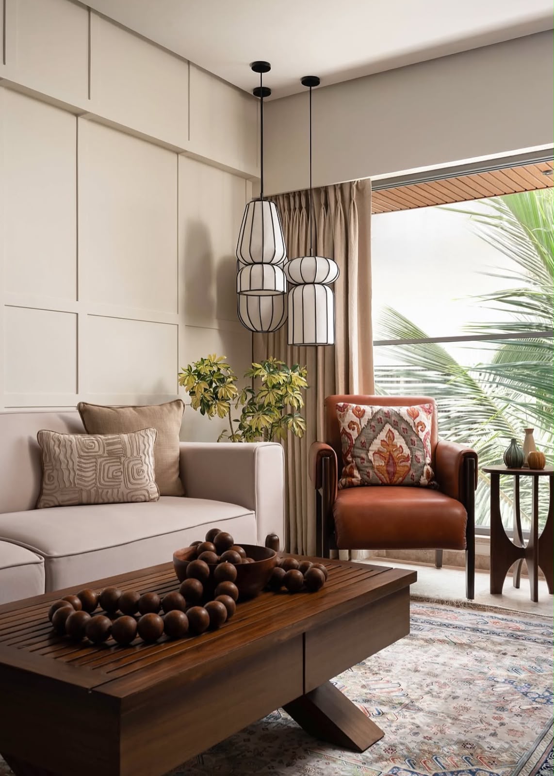 Living room with a beige sofa, a rust leather armchair and a dark wooden coffee table